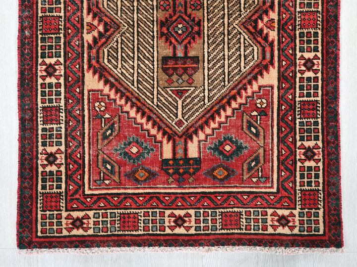 a red rug with a design on it