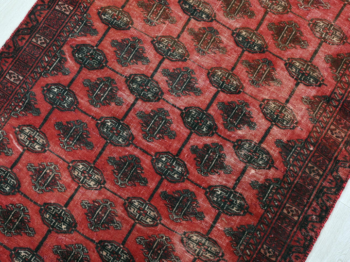 a close up of a red rug on a wooden floor
