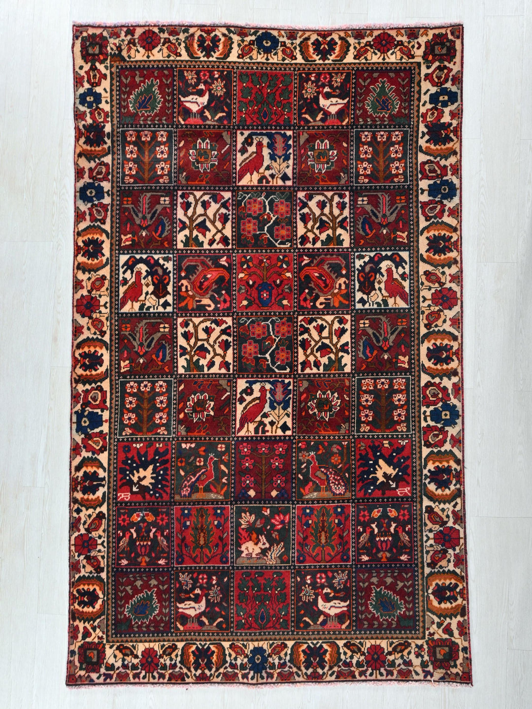 a red rug with a patchwork design on it