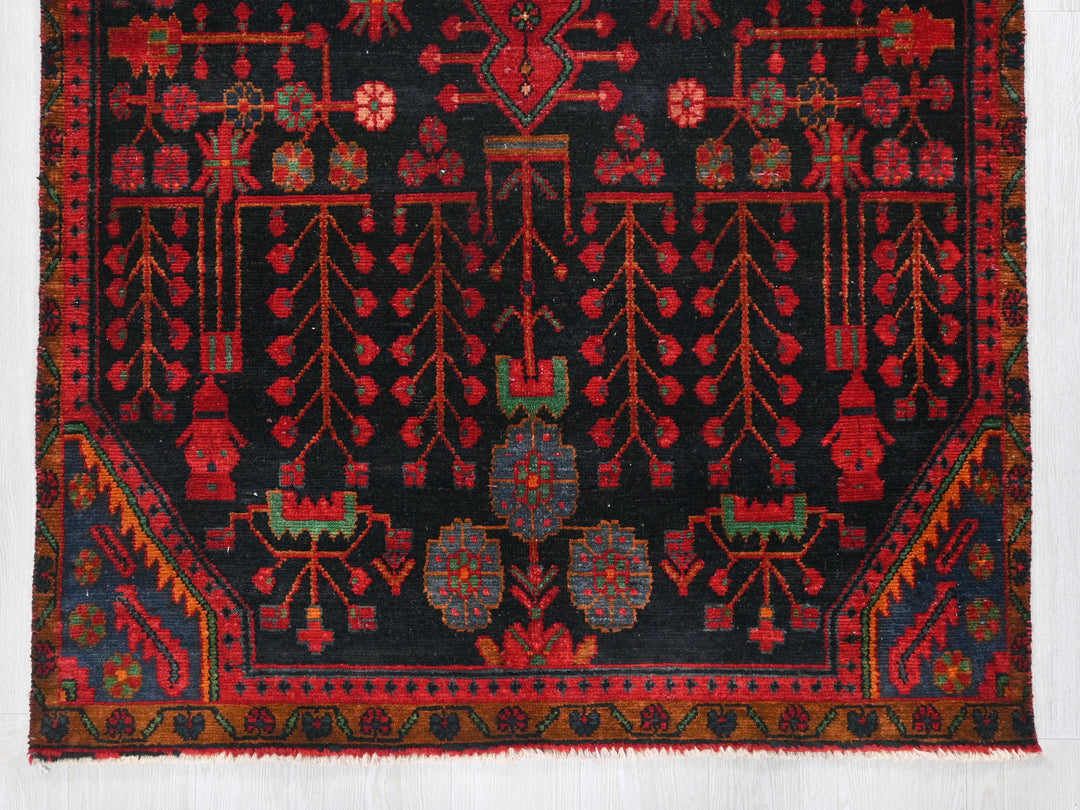 a red and black rug with a design on it