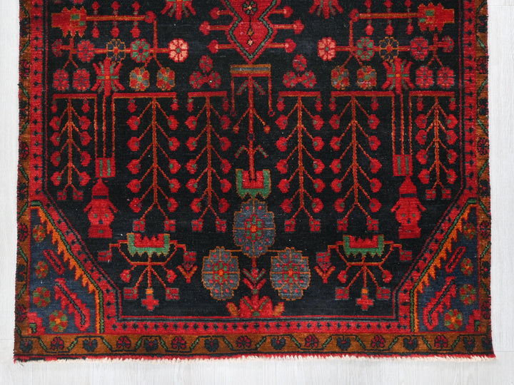 a red and black rug with a design on it