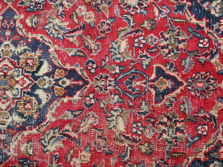 a red and blue rug with a floral design