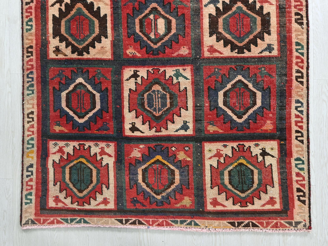 a multicolored rug on a white wall