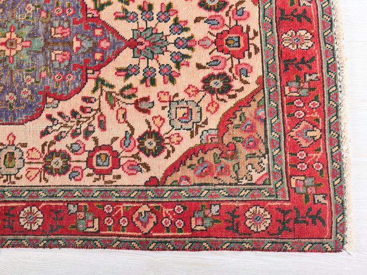 a red rug with a floral design on it