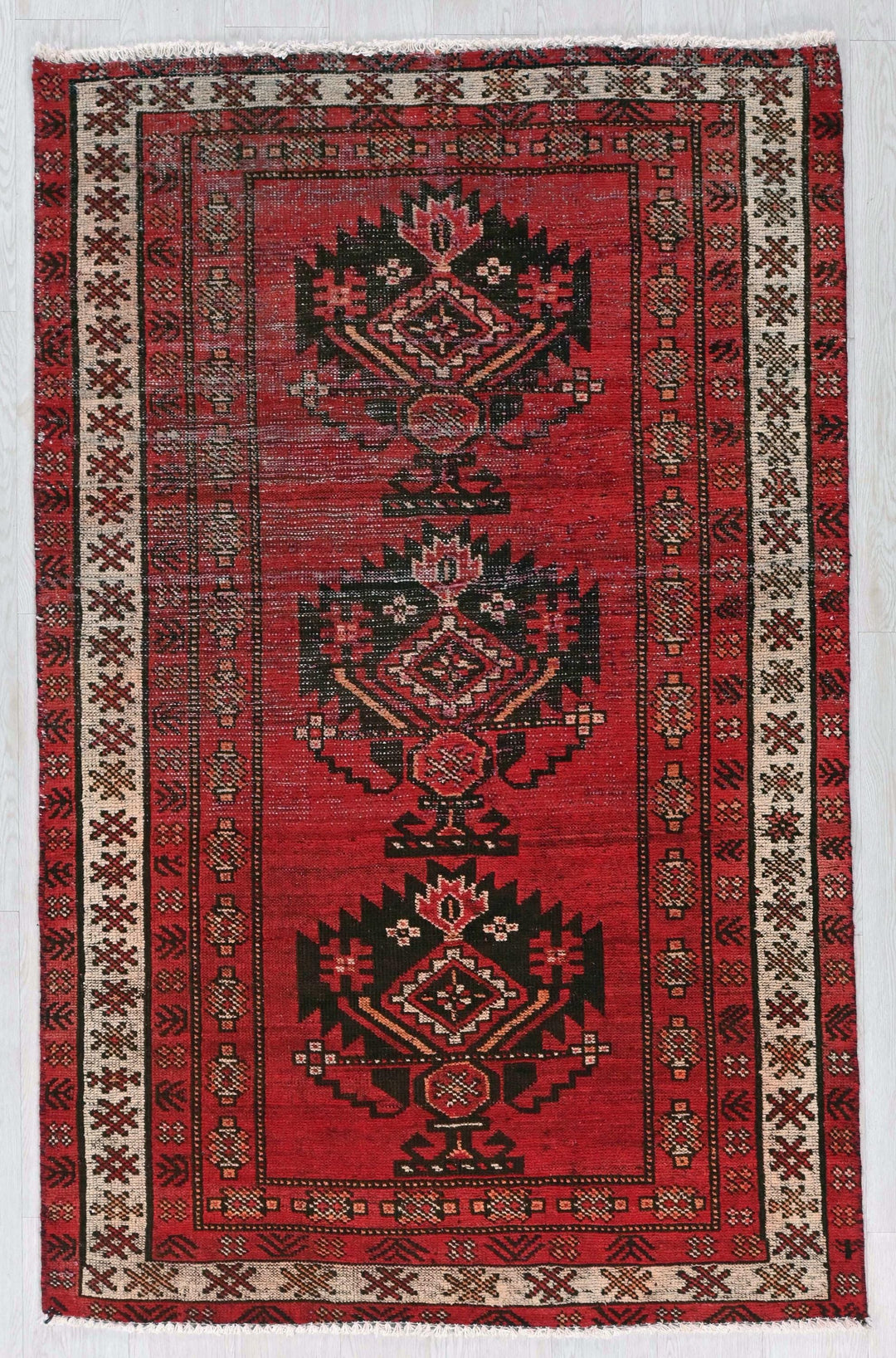 a red rug with a design on it