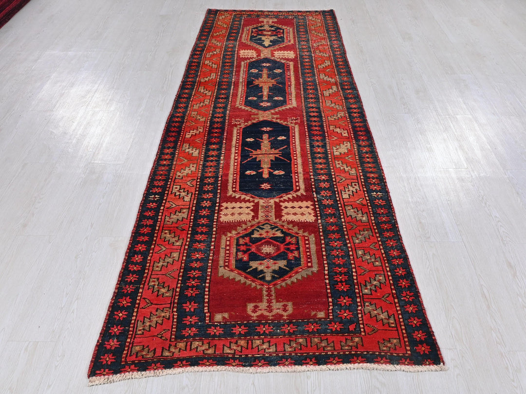 a red and blue rug on a white floor