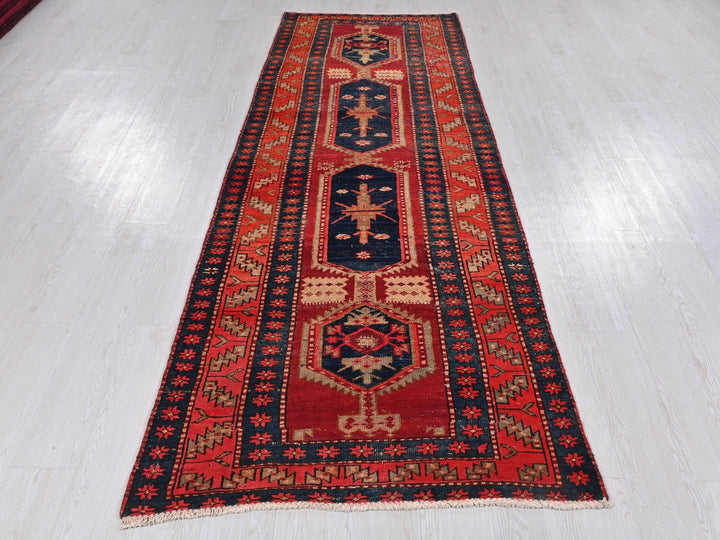 a red and blue rug on a white floor