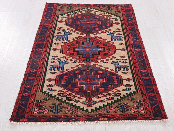 a red and blue rug on a white floor