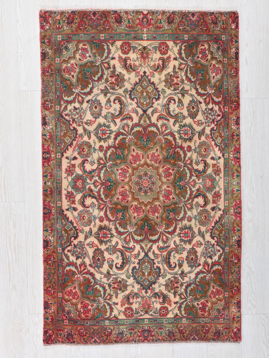 a red and green rug on a white floor