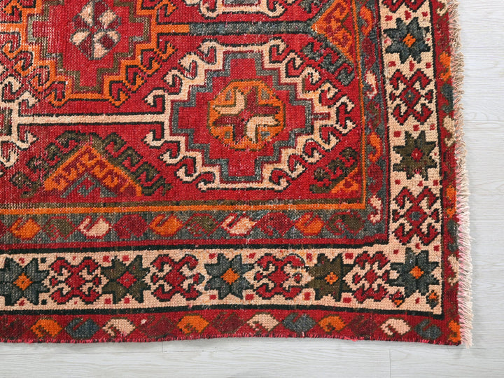 a red rug with a colorful design on it