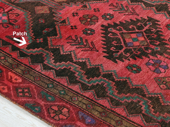 a close up of a rug with a patch in the middle