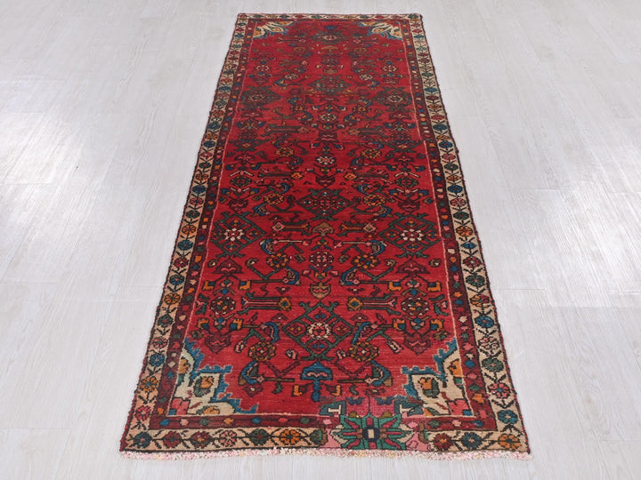 a long red rug on a white floor