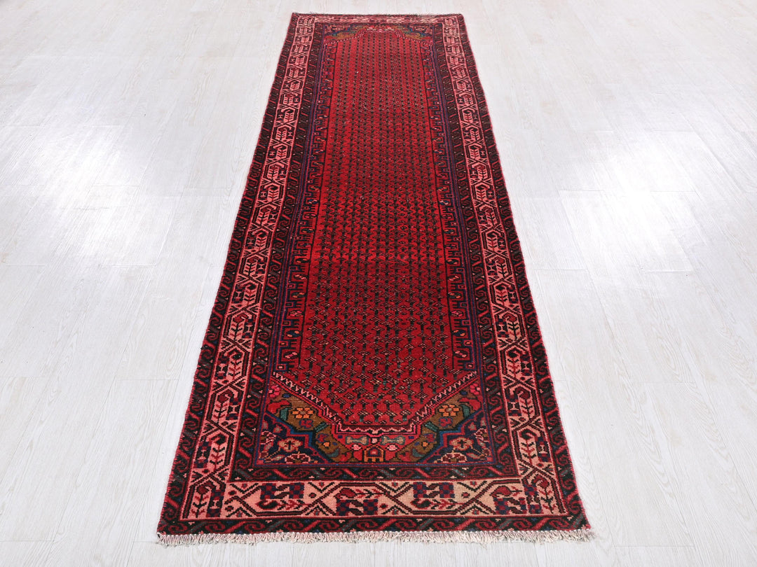 a red runner rug on a white floor