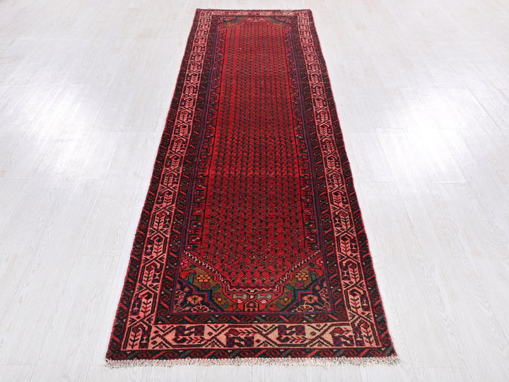 a red runner rug on a white floor