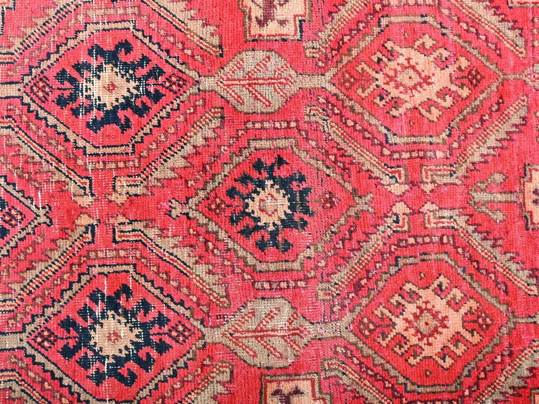 a close up of a red and black rug