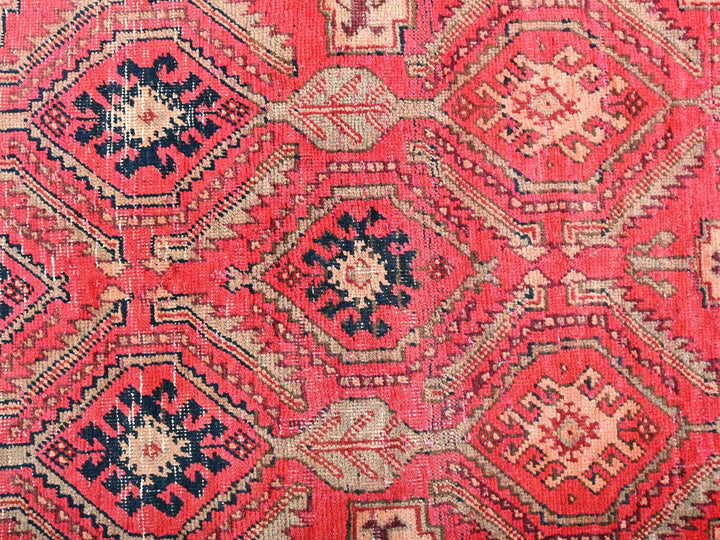 a close up of a red and black rug