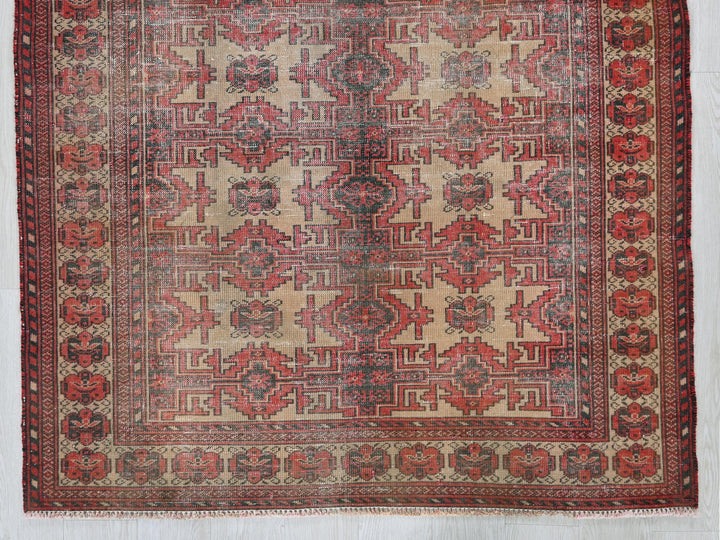 a red and beige rug on a white background