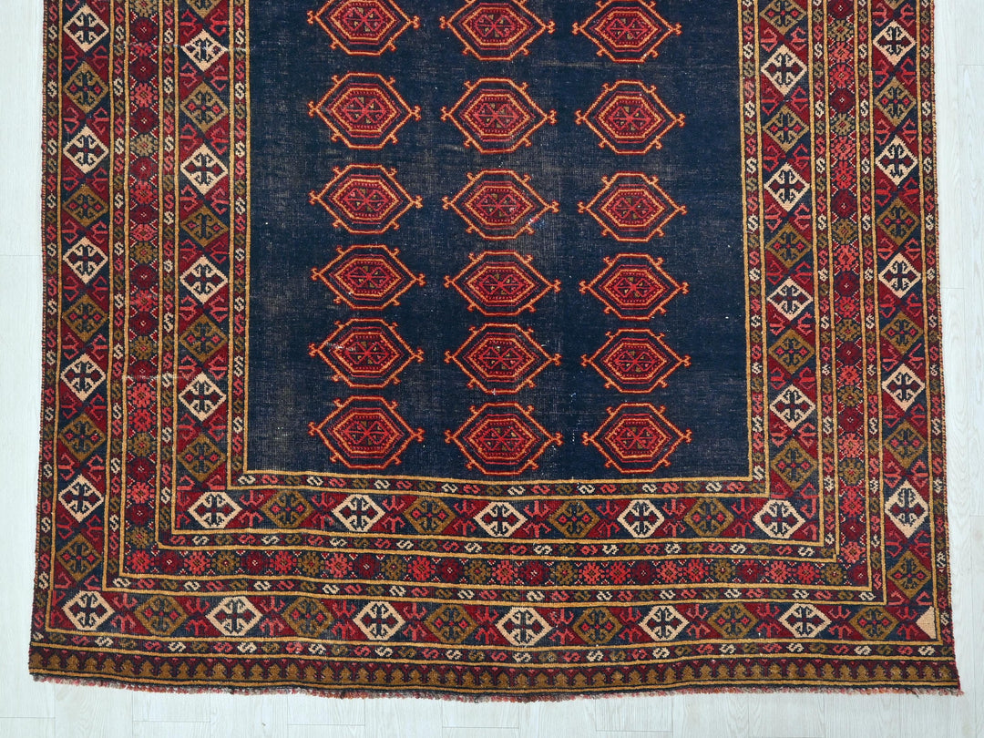 a blue rug with a red design on it