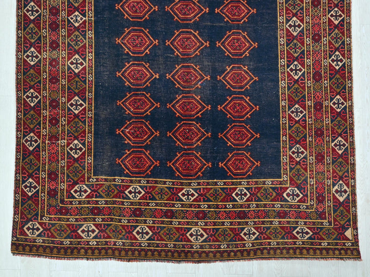 a blue rug with a red design on it
