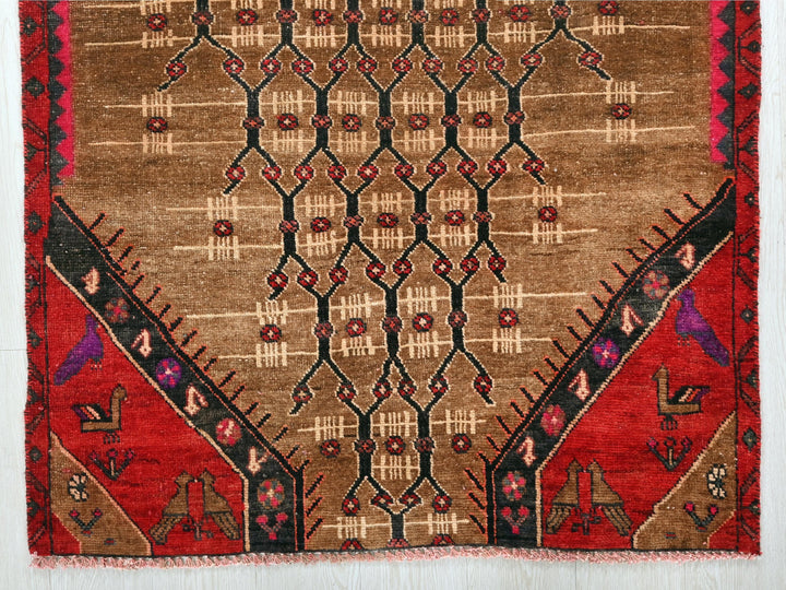 a brown and red rug with designs on it