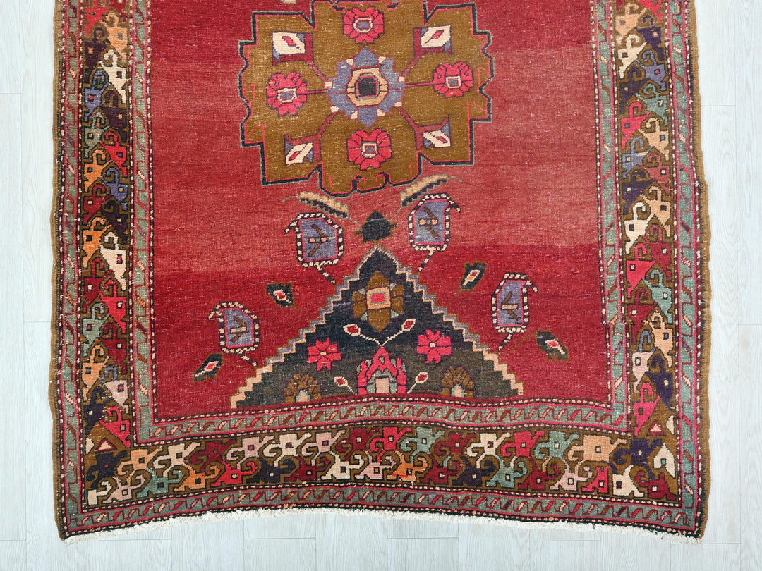 a red rug with a floral design on it