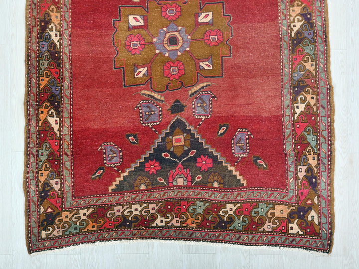 a red rug with a floral design on it