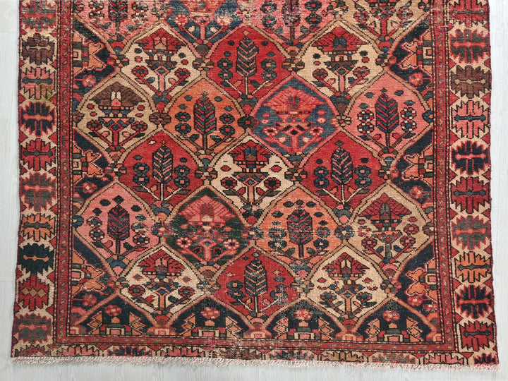 a red and blue rug on a white wall