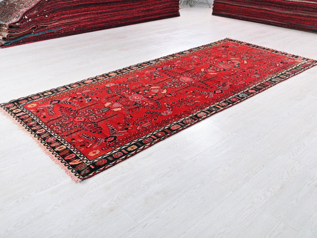 a red rug is laying on a white floor