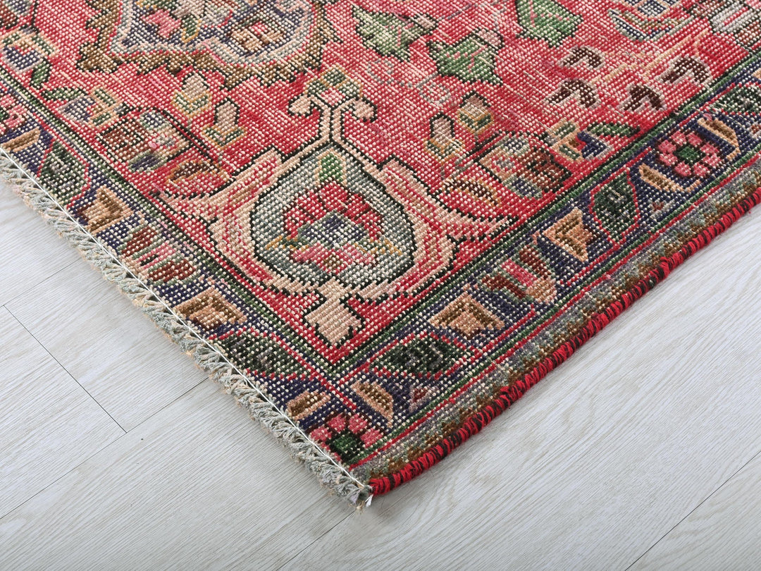 a close up of a rug on a wooden floor