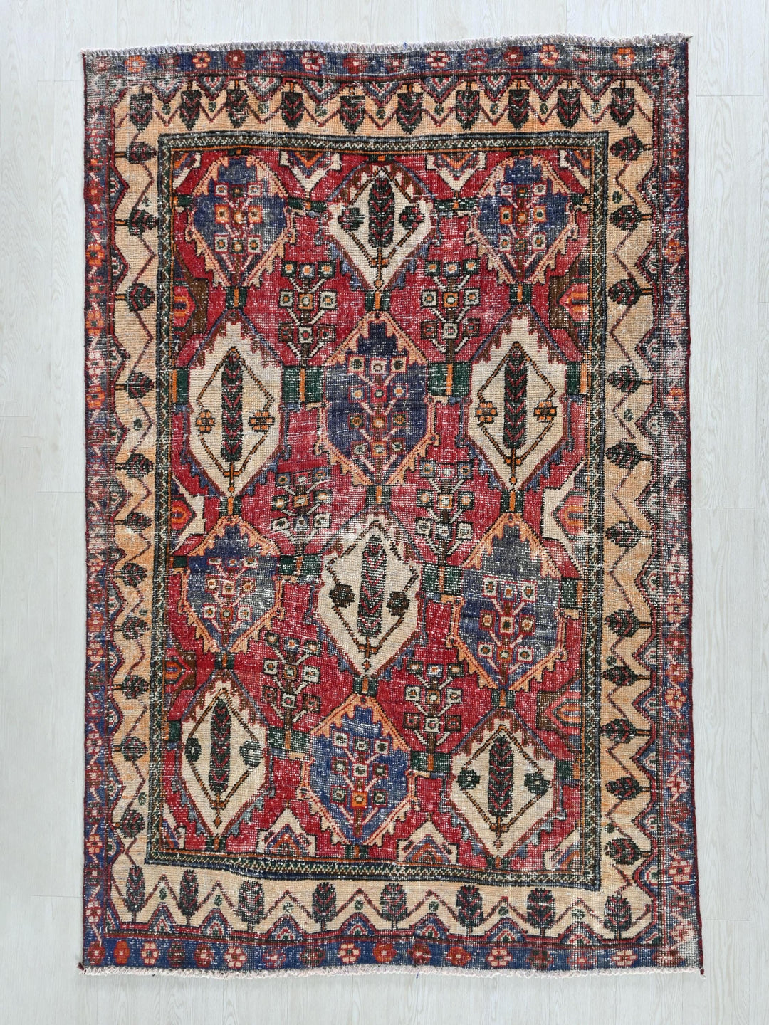 a red and blue rug on a white wall