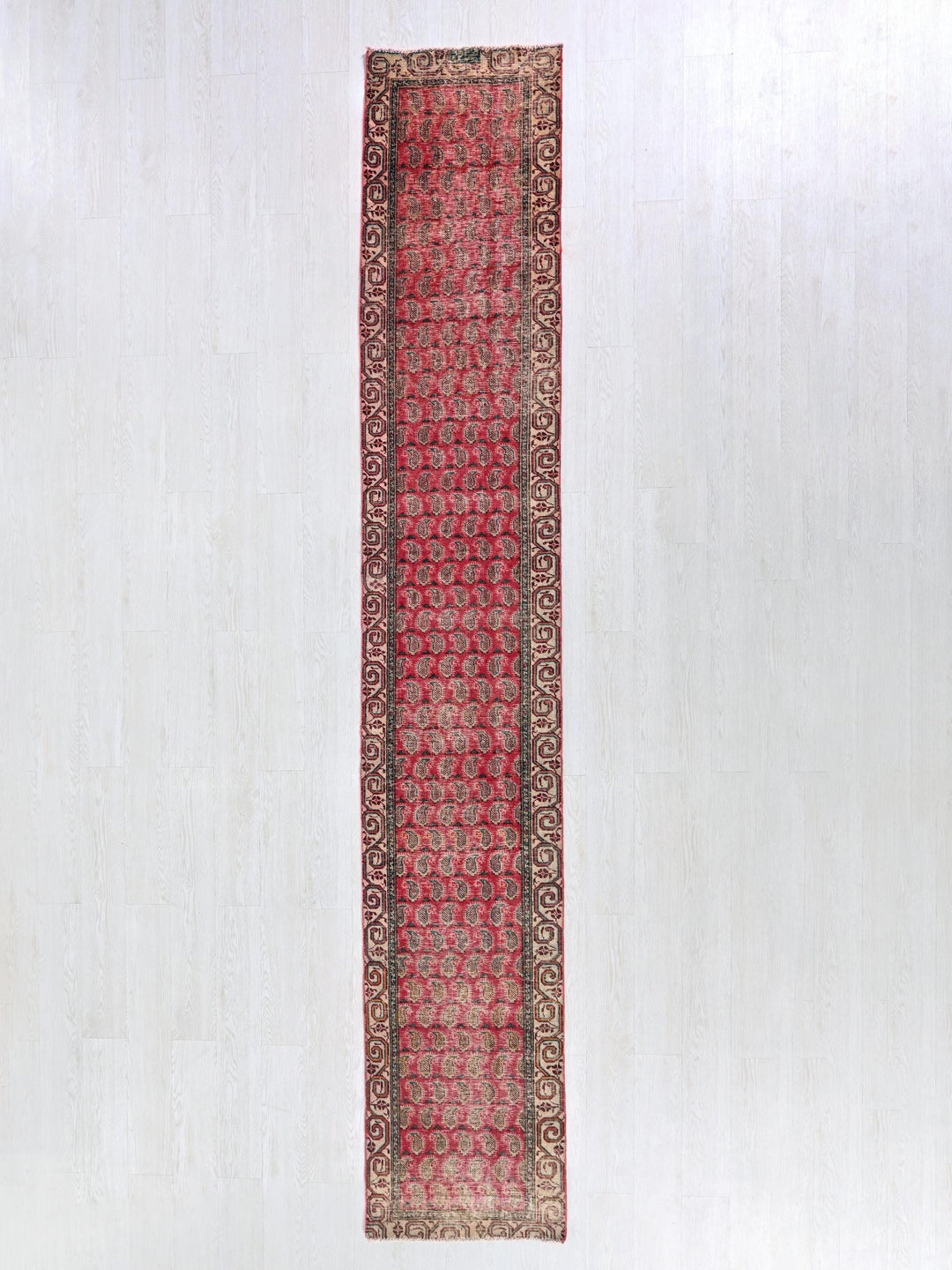 a red rug hanging up against a white wall
