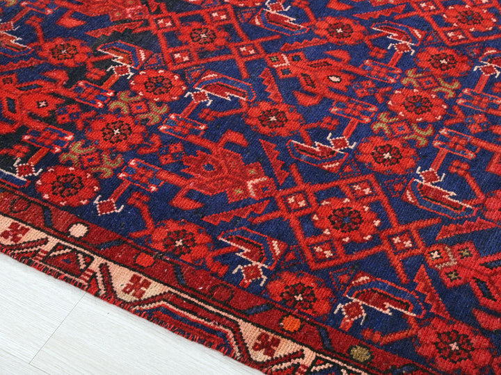 a red and blue rug on a white floor