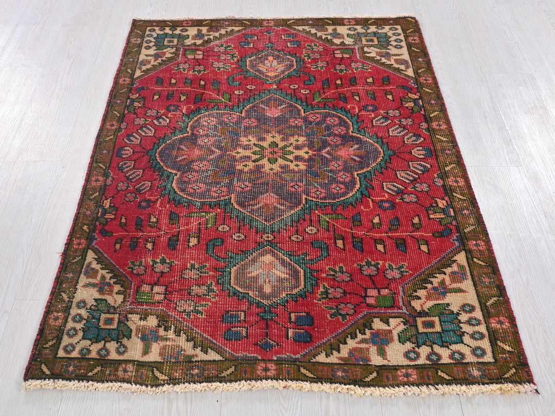 a red rug with a floral design on it