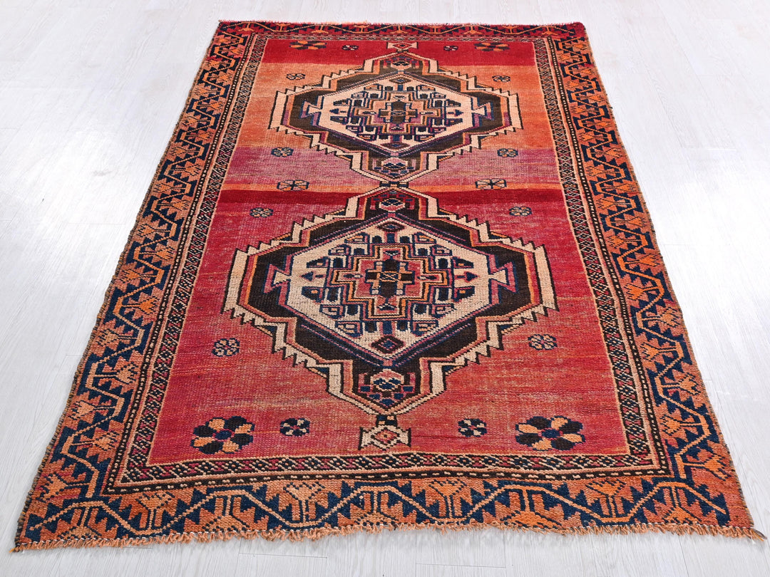 a red rug with an intricate design on it