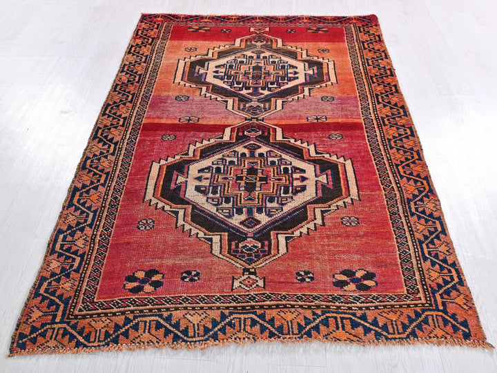 a red rug with an intricate design on it