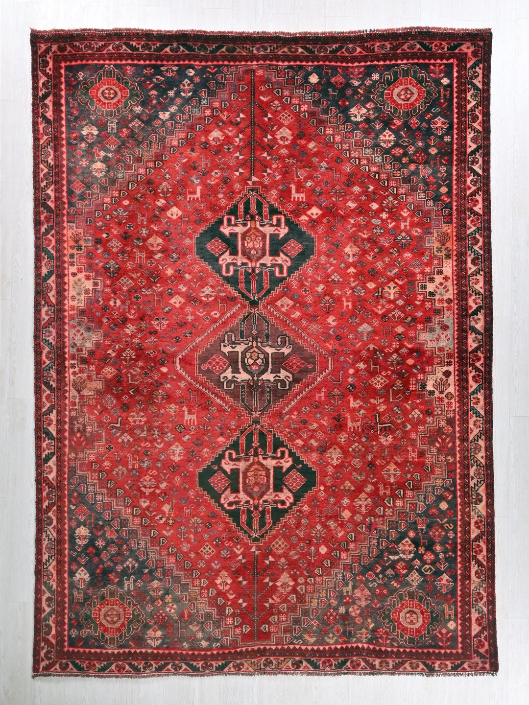 a red and black rug with a diamond pattern