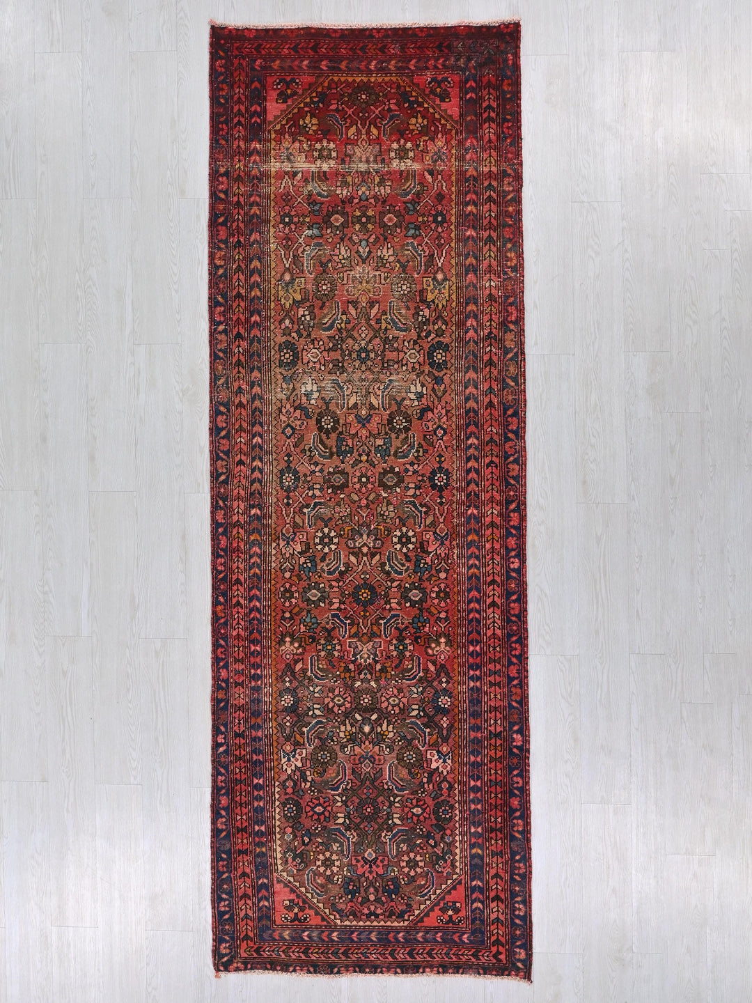 a red rug hanging up against a wall
