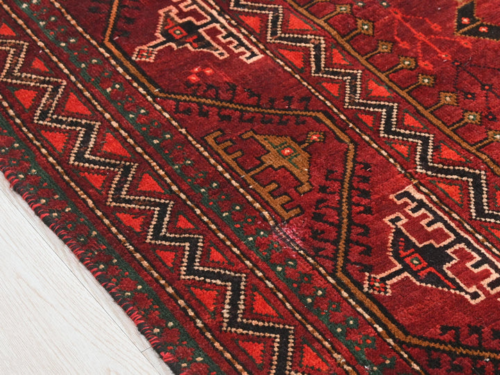 a close up of a red rug on the floor