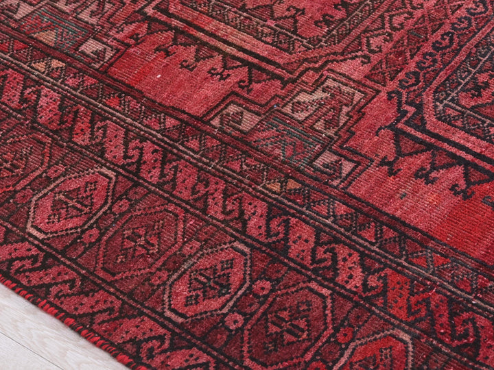 a red rug with a pattern on it