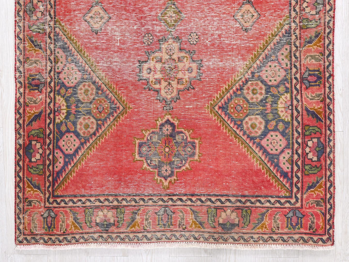 a red, blue, and green rug with a design on it