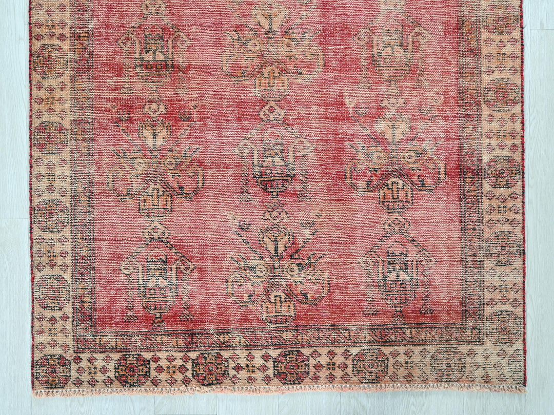 a red rug with a pattern on the middle of it