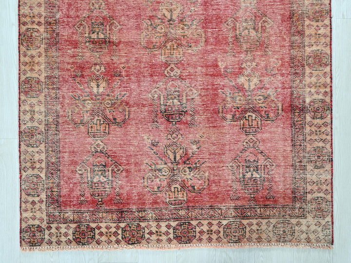 a red rug with a pattern on the middle of it