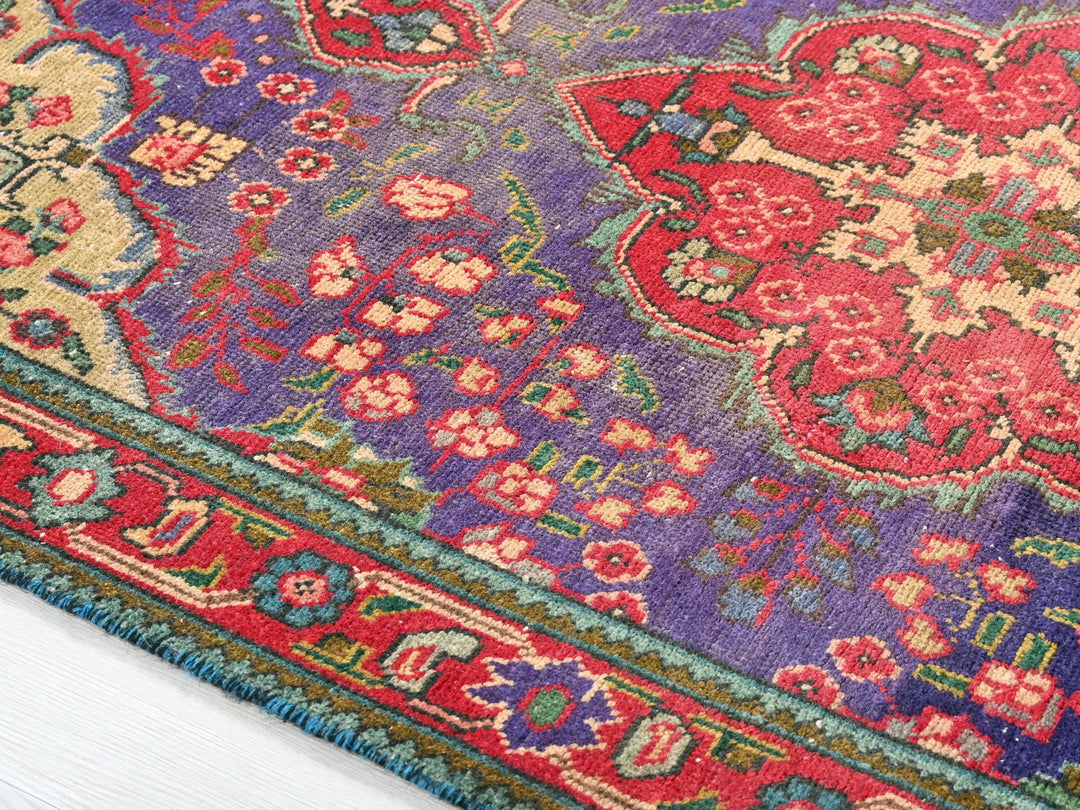 a colorful oriental rug on a white wooden floor