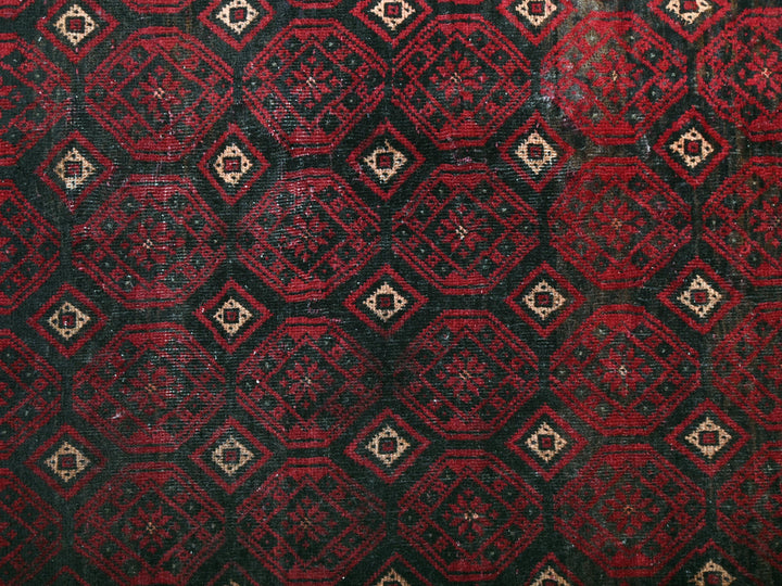 a red and black area rug with a design on it