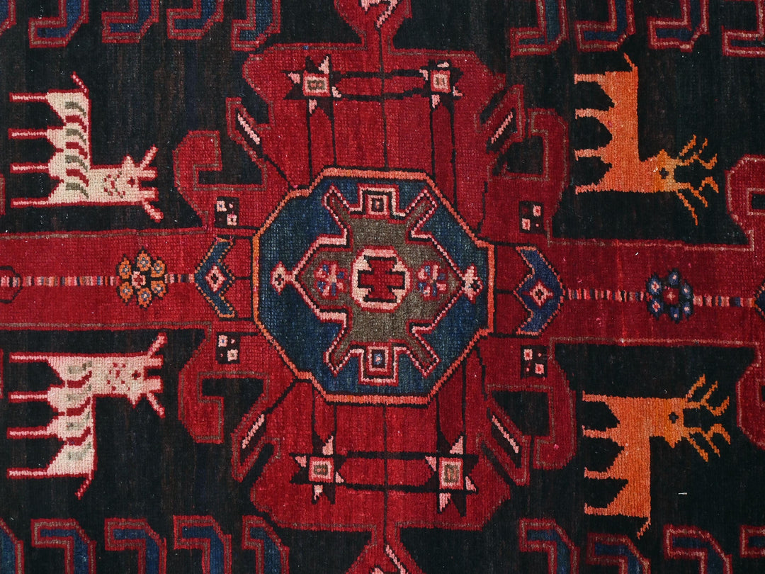 a red and black rug with a design on it