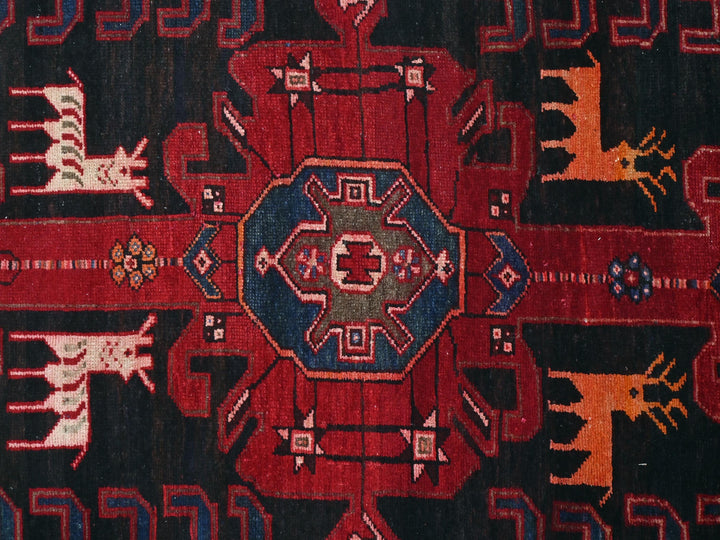 a red and black rug with a design on it