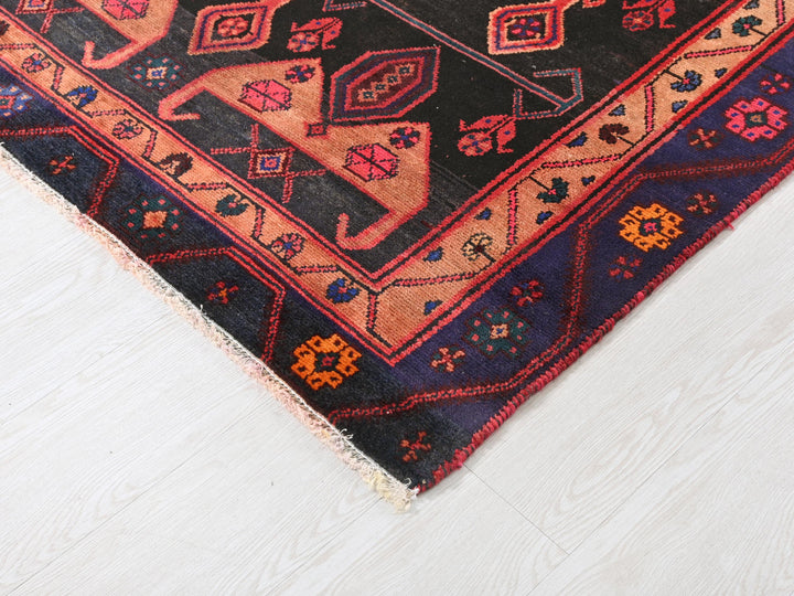a rug with a black background and a red and blue design