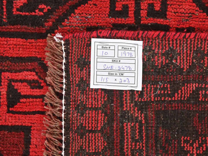 a red and black rug with a tag on it