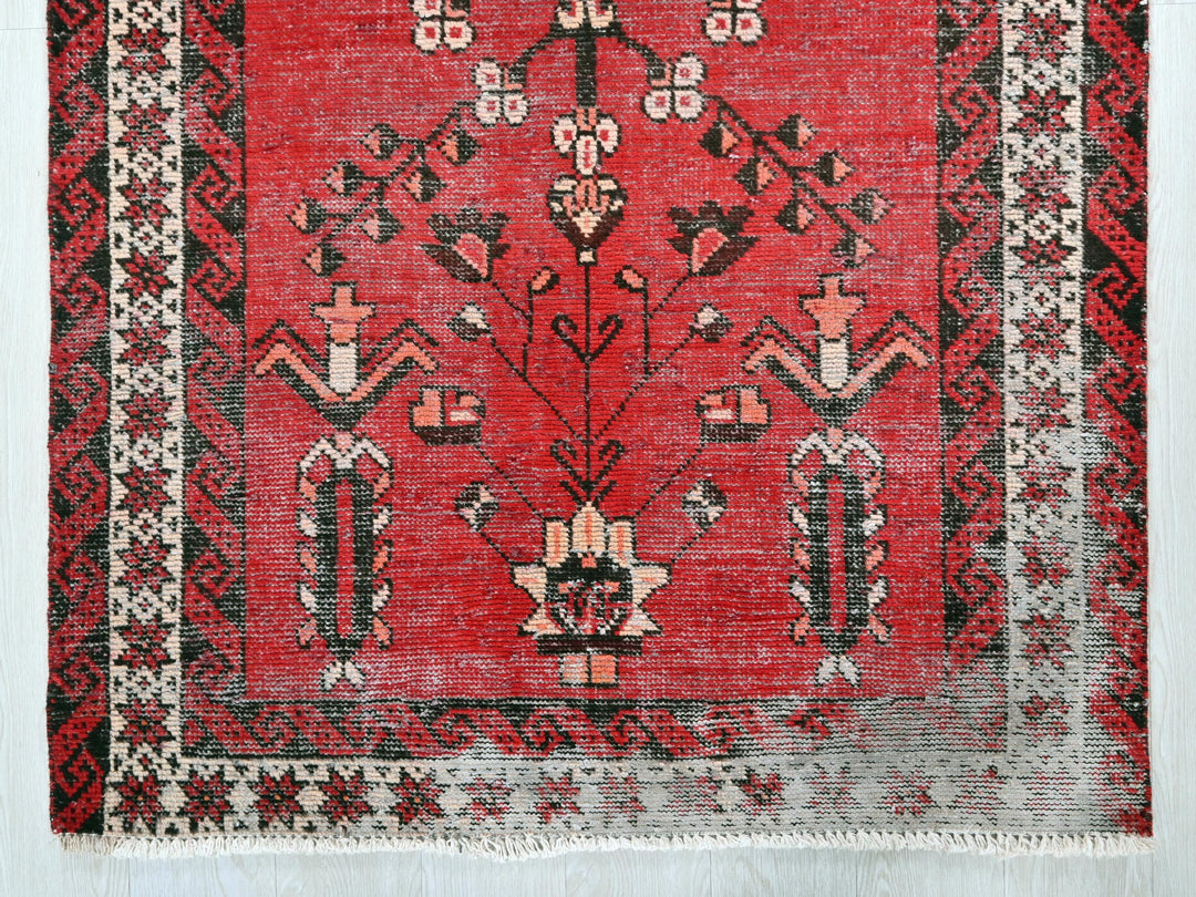a red rug with black and white designs on it