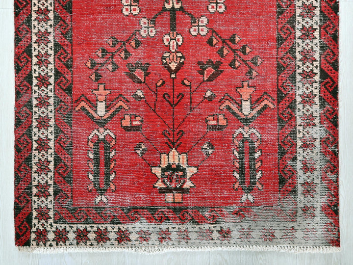 a red rug with black and white designs on it